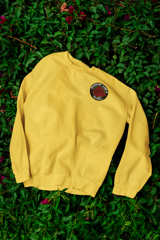 Yellow signature sweatshirt with a logo on a green leafy background